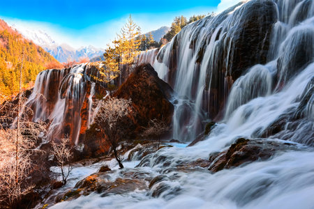 Autumn waterfall in Yading national level reserve, Daocheng, Sichuan Province, China.の写真素材