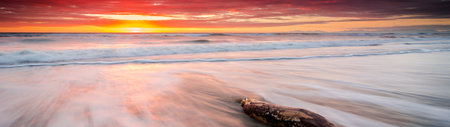 Panoramic view of a beautiful sunset over the ocean. Long exposureの写真素材