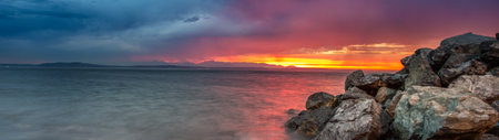 Sunset over the sea. Panoramic view. Long exposure.