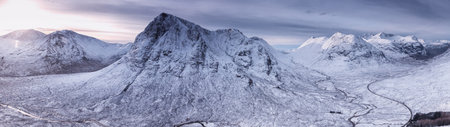 Panoramic view of snow capped mountain peaks in Scotland, UKの写真素材