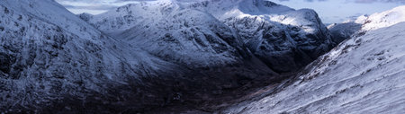 Panoramic view of snow covered mountains in Scotland, United Kingdomの写真素材
