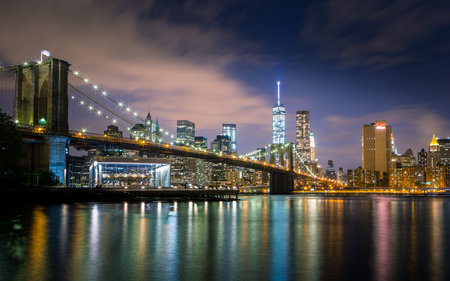 Manhattan skyline and Brooklyn Bridge at night, New York City.の写真素材