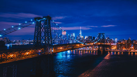 Manhattan Bridge and Manhattan skyline at night, New York City.の写真素材