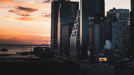 New York City Manhattan skyline at sunset with skyscrapers and Hudson River.の写真素材