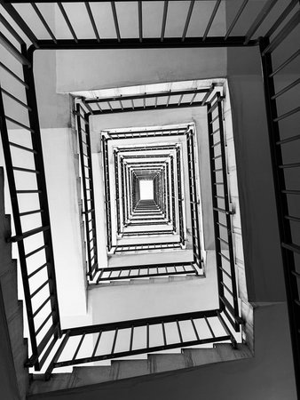 Black and white spiral staircase in a modern building, perspective view.の写真素材
