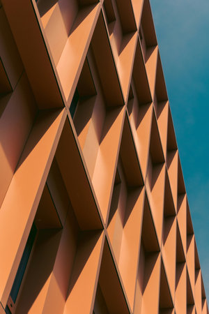 Abstract background of modern architecture. Orange facade of a modern building.の写真素材