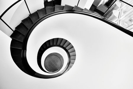 Black and white spiral staircase in a modern office building, perspective viewの写真素材