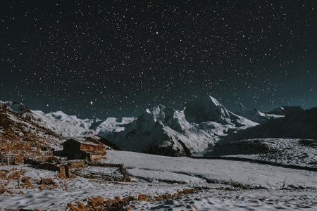 Mountain landscape at night with starry sky and snow covered houses