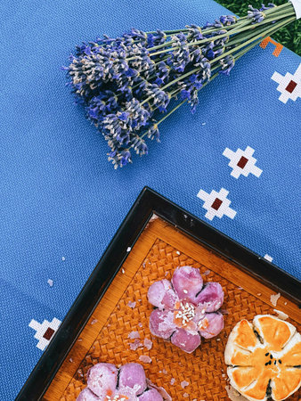Flat lay composition with lavender flowers and cookies on blue backgroundの写真素材