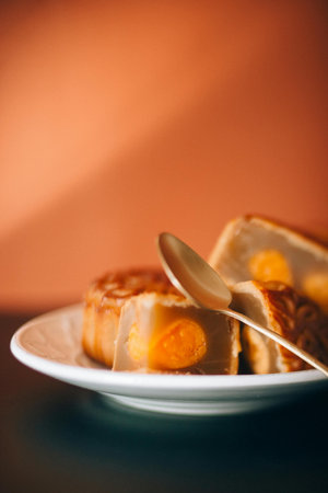 Cake with egg yolk on plate and orange background, selective focusの写真素材