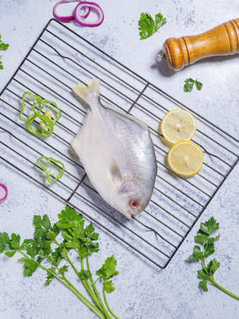 Raw fish with lemon and parsley on a white background. Selective focus.の写真素材