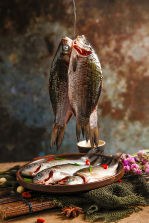 Fresh fish with spices and herbs on a dark rustic background.の写真素材