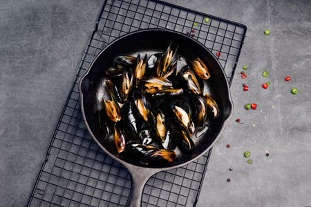 Mussels in a frying pan on a gray background. Top view.の写真素材