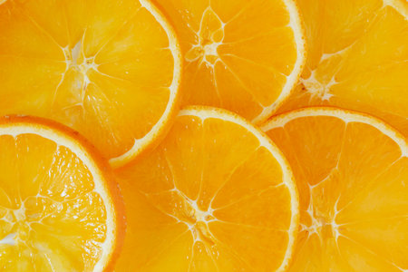 Slices of fresh orange fruit as a background, top view