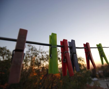 clothes pegs hanging on the ropeの写真素材