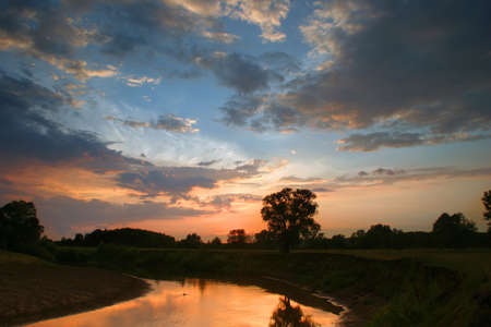 sunset on the river in the middle of summerの写真素材