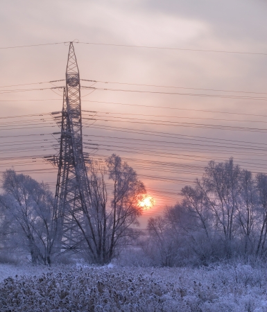 An unusual view of the high voltage on a snowy meadowの写真素材