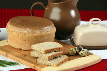 close-up of sliced bread on a cutting board and other edibles studio
