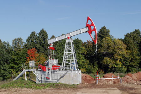 Oil pump on  autumn forest and blue skyの写真素材