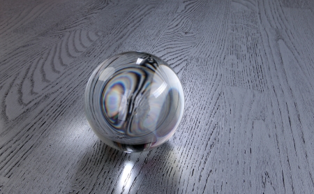 close-up clear glass ball on a gray wooden dance floor studioの写真素材