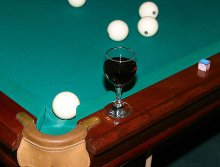 close-up of a billiard table with green cloth with balls and cue