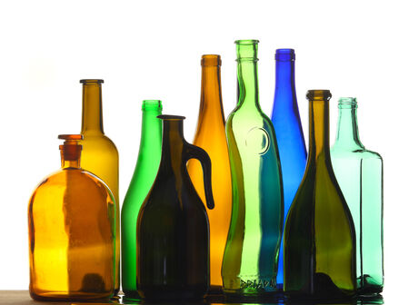 isolated close-up collection of beautiful colored empty bottles on white studio backgroundの写真素材