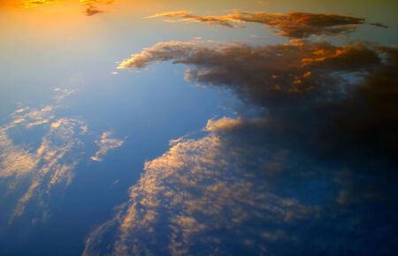 beautiful clouds colored glow of the setting sun on the sky background