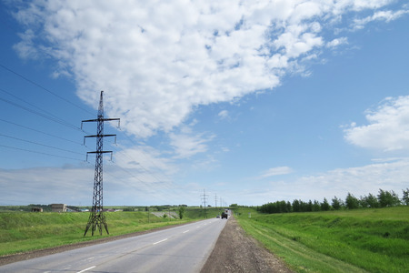 summer landscape field and power lines on a sunny afternoonの写真素材