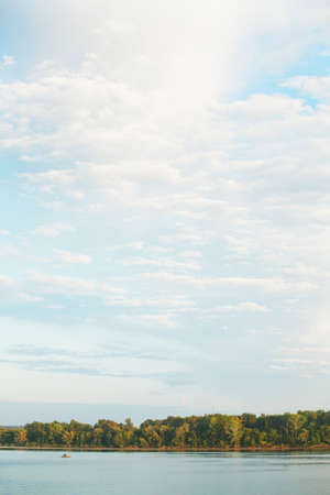 beautiful summer landscape beautiful sunset over the river, beautiful clouds and trees on the shoreの写真素材