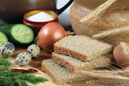 close-up of sliced bread on a cutting board and other edibles studioの写真素材