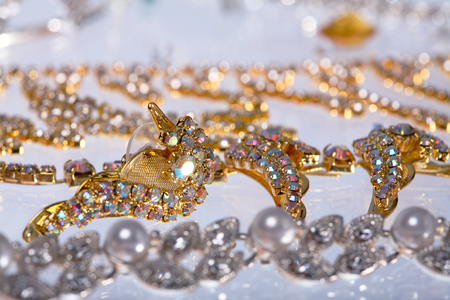macro beautiful graceful diverse jewelry, necklaces and earrings with colored stones on white background studioの写真素材