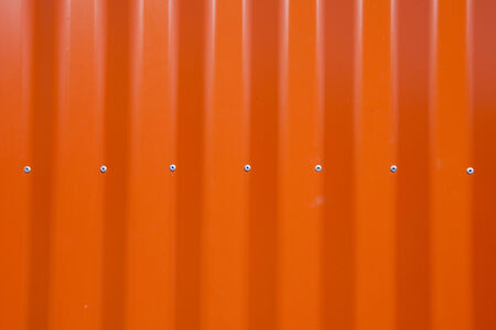 isolated macro texture fragment of the new orange metal fenceの写真素材