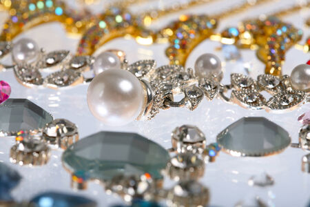 macro beautiful graceful diverse jewelry, necklaces and earrings with colored stones on white background studioの写真素材