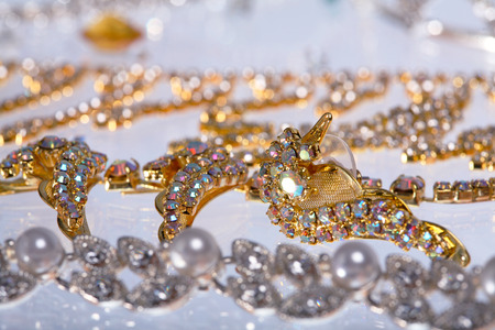 macro beautiful graceful diverse jewelry, necklaces and earrings with colored stones on white background studioの写真素材