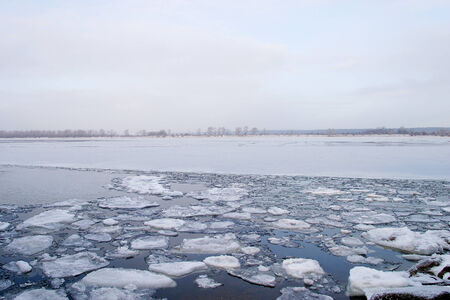 winter landscape wide navigable river is partially covered with ice in early winter cloudy day