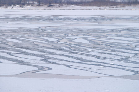 winter landscape wide navigable river is partially covered with ice in early winter cloudy day