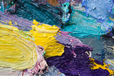 macro artist's palette, texture mixed oil paints in different colors and saturation studioの写真素材