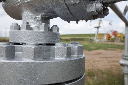 close-up big oil pipeline valves silver color on a background cloudy sky