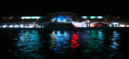 seaside resort hotel building and landscaped grounds with pool in summer nightのeditorial素材