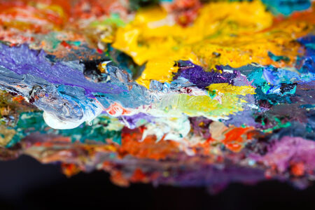 macro artist's palette, texture mixed oil paints in different colors and saturation studioの写真素材