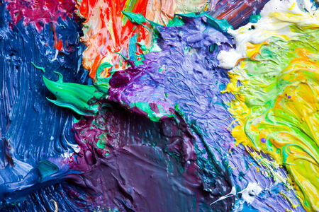 macro artist's palette, texture mixed oil paints in different colors and saturation studioの写真素材