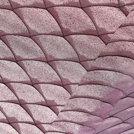 close-up texture fragment of the roof tiles with a soft red in the sunlightの写真素材