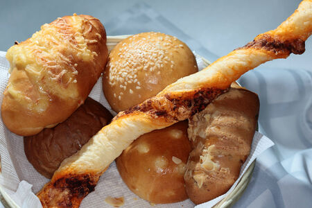 Macro of assorted baked goods on a napkin in a basket on a black background studio