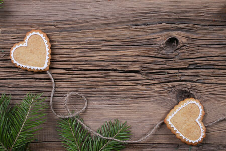 close-up of beautiful festive Christmas still life of the branches of spruce, cookies and spice on wood with cracks studioの写真素材