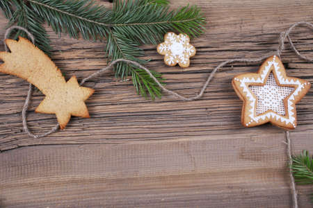close-up of beautiful festive Christmas still life of the branches of spruce, cookies and spice on wood with cracks studioの写真素材