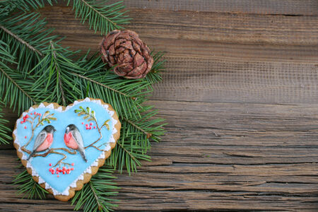 close-up of beautiful festive Christmas still life of the branches of spruce, cookies and spice on wood background with cracks studioの写真素材