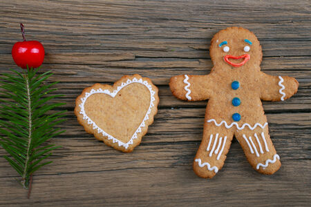 close-up of beautiful festive Christmas still life of the branches of spruce, cookies and spice on wood with cracks studioの写真素材