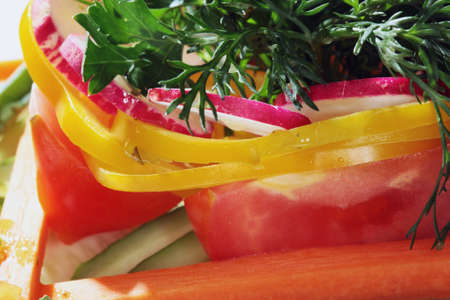 macro bright vegetable salad on a white plate on a black background studioの写真素材
