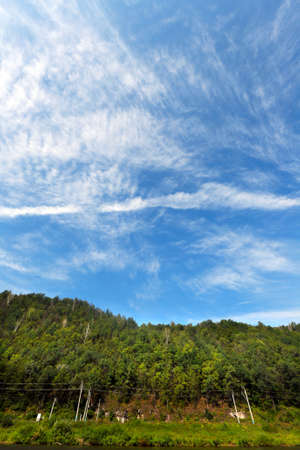 close-up whimsical cirrus clouds against blue skyの写真素材