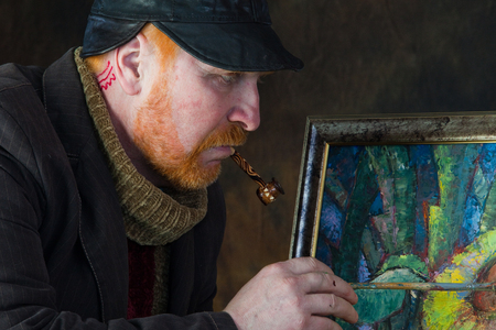 close-up portrait of the adult artist with red beard and mustache in the style of Vincent van Gogh studio on dark backgroundの写真素材